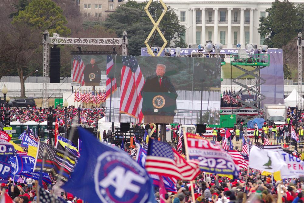 U.S. President Donald Trump appears on large screens as he speaks at the "Stop the Steal" rally at the Washington